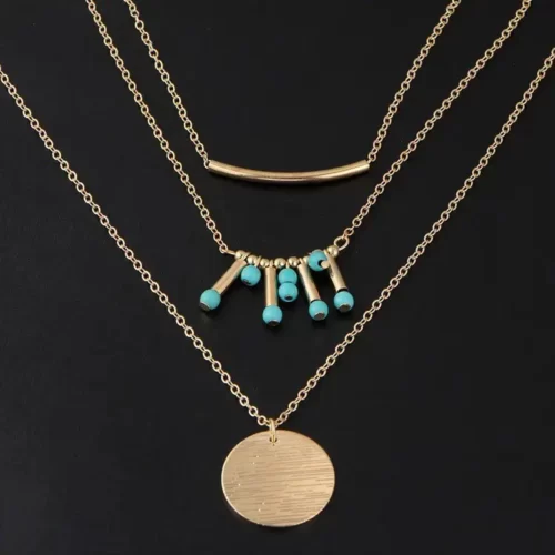 the gold edition of the Attractive Boho Turquoise Multilayered Necklace on a black velvet