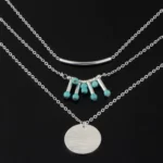 silver edition of the Attractive Boho Turquoise Multilayered Necklace on a black velvet