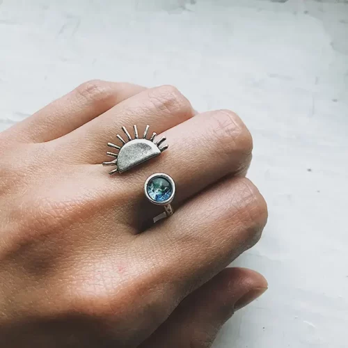 the silver edition of the Beautiful Handmade Sunrise Ring on a hand