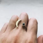 Daring Crescent Moon Ring With Black Onyx on a finger