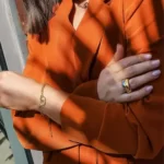 a woman wearing the ring of the Beautiful Golden Paperclip Link Jewelry Set