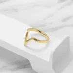 Minimalist V-Shape Geometric Outline Ring on a white stand