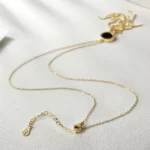 close up photo mof the lobster claw clasp of the Long Tassel Pendant Necklace