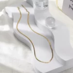 Charming Golden Venice Necklace on a white stand