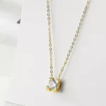 Dainty Golden Cubic Zirconia Pendant Necklace on a white background