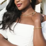 a woman in a white dress wearing the Fascinating Le Cheval Bracelet on her arm