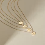 4 Gold Initial Fine Necklaces creating the word love