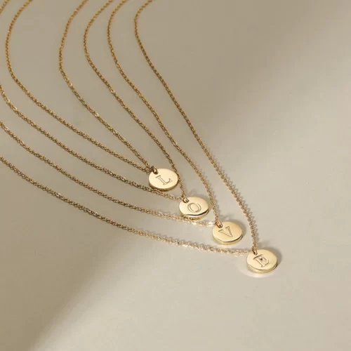 4 Gold Initial Fine Necklaces creating the word love