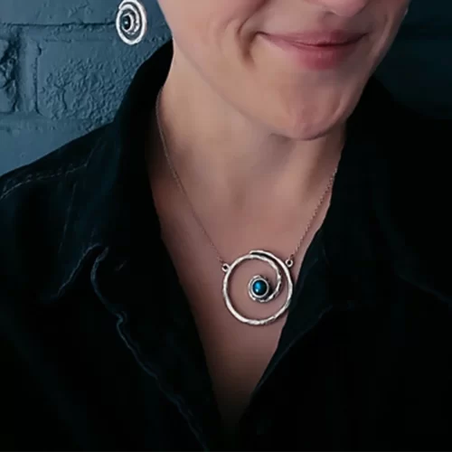 a woman wearing the Marvelous Handmade Spiral Silver Necklace on her neck