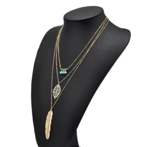 New Boho Turquoise Leaf Feather Layered Necklace gold edition on a black mannequin