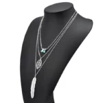 New Boho Turquoise Leaf Feather Layered Necklace silver edition on a black mannequin