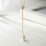 close up photo of the Pearl Drop Gold Pendant Necklace With CZ on a white background