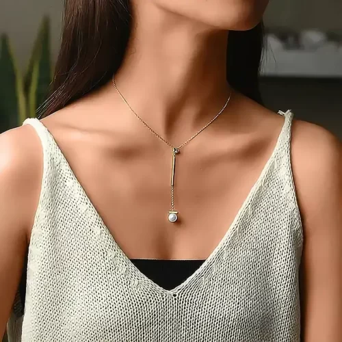 a woman with a V-top wearing the Pearl Drop Gold Pendant Necklace With CZ on her neck