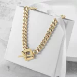 Square Toggle Clasp Golden Chain Necklace on a white gift box