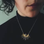 a woman wearing the Unique Handmade Sun Pendant With Turquoise on her neck