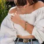 the golden edition of the Daring CZ Ball Link Bracelet on a woman's arm