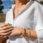 the Exciting Golden Heartbeat Bracelet on a woman's arm