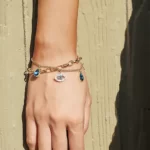 a woman wearing the Golden Evil Eye Bracelet on her wrist