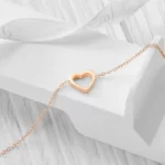 the rose gold Open Heart Charm Bracelet on a white background