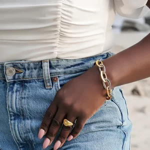 the Mind-Blowing 2 Tone Oval Link Bracelet on a black woman's hand