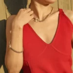 a woman in a red dress wearing the Mind-Blowing Golden Toggle Clasp Bracelet on her arm