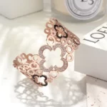 close up photo of the Seductive Hollow Clover Wide Cuff Bracelet in rose gold