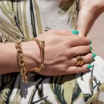 a woman in a floral dress wearing the Spectacular Golden Vintage Jewelry Set