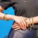 a woman in a black t-shirt is wearing the Spectacular Golden Vintage Jewelry Set