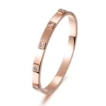 the rose gold version of the Striking Metal Stone Hinged Bangle