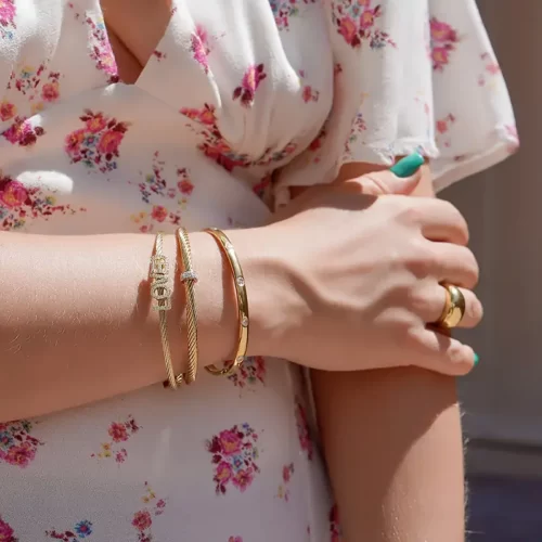 a woman wearing the Wonderful Golden Bangle With Zirconia on her arm