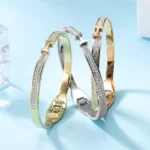 the three versions of the Wonderful Thin H-Shaped CZ Bangle on a blue background