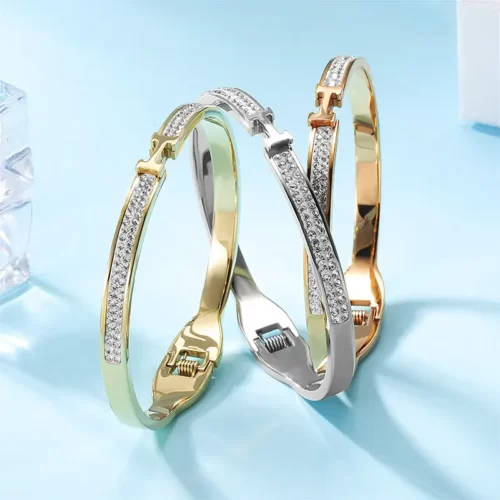 the three versions of the Wonderful Thin H-Shaped CZ Bangle on a blue background