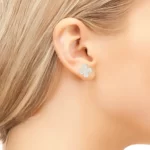 a woman with blond hair wearing the 4 Leaf Clover Earrings With CZ