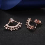 the 925 Sterling Silver Pave Ear Jacket Earrings in rose gold plating on a black background