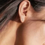 close up photo of a woman wearing the Adorable Golden Bar CZ Stud Earrings