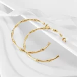 the Amazing Golden Bamboo Earhoops on a white background