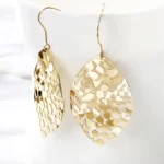 close up photo of the gold Astonishing Leaf Dangle Drop Earrings on a white background