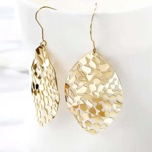 close up photo of the gold Astonishing Leaf Dangle Drop Earrings on a white background