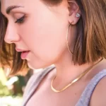 a woman wearing Basket-Set Round CZ Stud Earrings