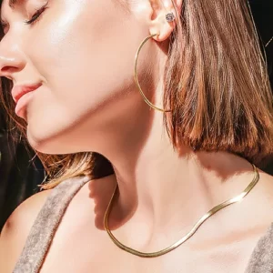 a woman wearing the Beautiful Golden Hoop Earrings