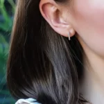 a woman wearing the Stunning Rainbow Hoop Earrings